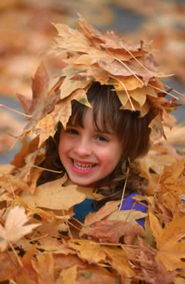 Clean Gutters and Drains Protect Your House and Garden - child playing in leaves